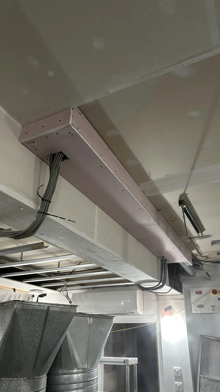 Boarded beam encasement around services