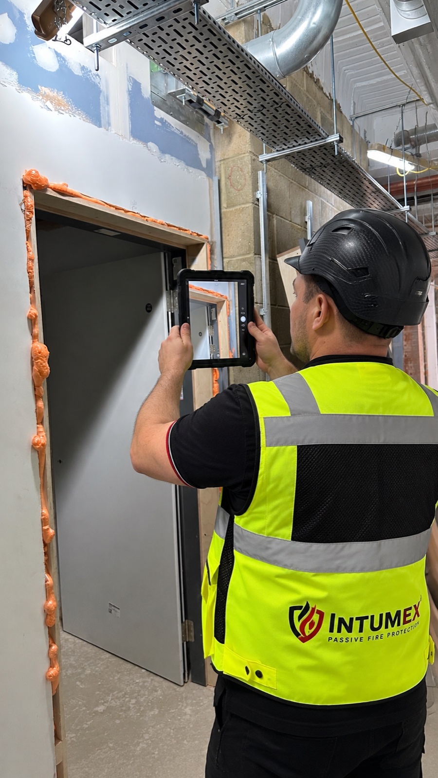 INTUMEX specialist recording fire protection evidence on a tablet